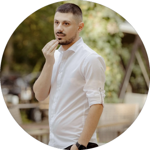 waist-up-portrait-handsome-serious-unshaven-male-keeps-hands-together-dressed-dark-blue-shirt-has-talk-with-interlocutor-stands-against-white-wall-sel